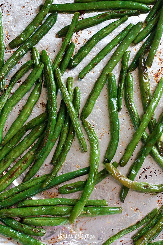 green beans + olive oil + salt +pepper + garlic powder +parmesan. 425 degrees for 10 min. shake. then another 5 min.add parm cheese. Yum!