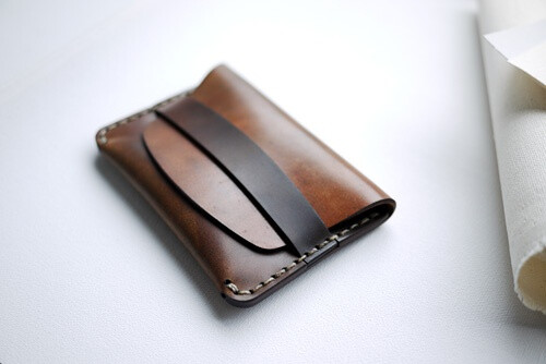 FLAP SLIM WALLET 2011-03-22 13:40:27 CORDOVAN FLAP SLIM WALLET Scraped Cordavan Single pocket card/cash holder. Scraped Horween Cordovan leather. Slim profile. Seam integrated keeper. Hand sewn, edge burnished and polished. Each piece is unique. 4.25" × 3" × .3" Regular Price: $200.00