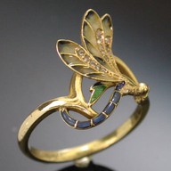 Art Nouveau style is the theme of the dragonfly as well as the use of the enamel. This way of enameling is called plique ajour. 1890-1905 France. Adin Antique Jewellery.