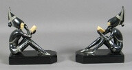 Art Deco Figural bookends, stylish women in black and silver painted spelter with faux ivory faces and books rest on shaped rectangular black marble or glass bases.