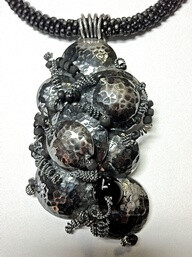 Sterling silver lentil beads on blavk Kumihimo braid. Jude Carmona - Jude Designs