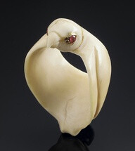 An unusual ivory Archer's Ring in the form of a Falcon probably Mughal, 18th Century formed by a three dimensional bird with ruby-set eyes and folded wings 4.5 cm. long