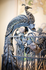 Wrought iron peacock on gate