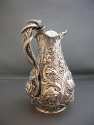 Sterling silver hot milk jug, London, 1872-73 with exceptional chasing and a snake wrapped around the handle. Made by William Smiley