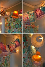 Cover plastic cups in fabric, attach to string lights! Pretty.