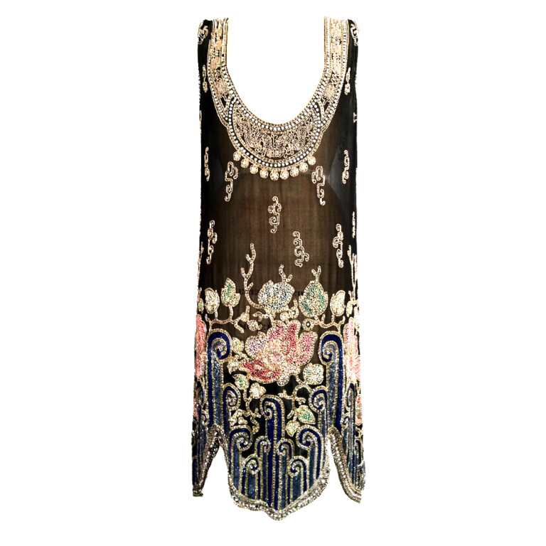 A rare and exquisite beaded flapper dress. Fine sheer black silk item features elaborately art deco beaded neck and hemline. An original unlabeled survivor that is structurally intact with very slight/minimal bead separation and or loss (none distracts and easily addressed by a competent seamstress)