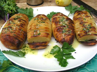 Hasselback Potatoes - Panning the Globe ( Russet potatoes Salt Garlic Black pepper Olive oil Lemon zest Lemon juice Flat leaf parsley)