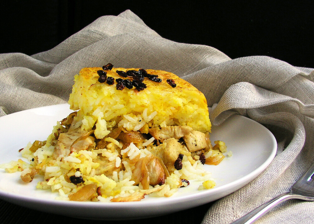 Persian Layered Chicken and Rice with Yogurt - Panning the Globe ( Ground turmeric Chicken breasts Saffron Garlic Black pepper Butter Basmati rice Eggs Onions Olive oil Barberries Yogurt Lemon juice Kosher salt)