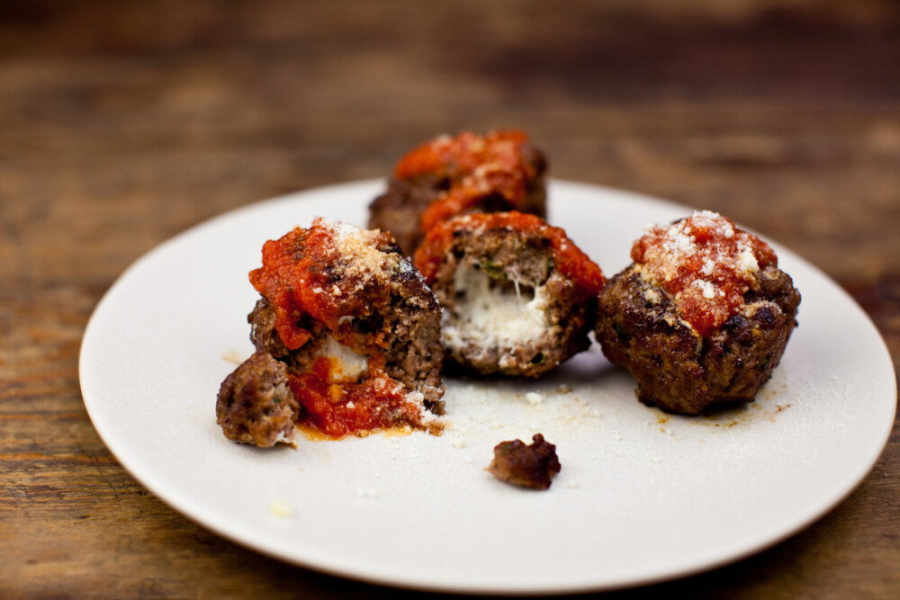 Cheese-Stuffed Meatballs Recipe - Food Republic (Dinner Dairy Vegetables Meat Gluten Egg products Animal products Appetizer / sides Fall meatballs Salt Garlic Black pepper Ground beef Bread crumbs Mozzarella cheese Eggs Parsley Onions Olive oil)