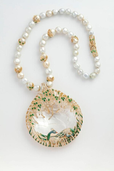 Peacock necklace from Jewels Emporium with a studded peacock sitting on a mother of pearl along with emeralds, diamonds, pearls and enamel.