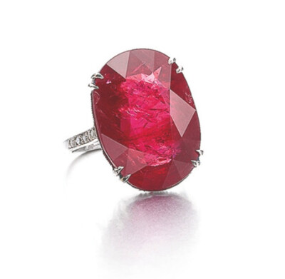 Set with an oval ruby weighing 14.13 carats, within a mount decorated to the front with single-cut diamonds, size 471/2.