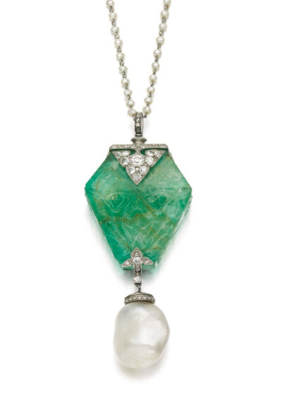 The emerald, carved in the Persian style, accented with palmette motifs and millegrain-set with circular-cut and rose diamonds, suspending a baroque natural pearl drop, later seed pearl chain, length …