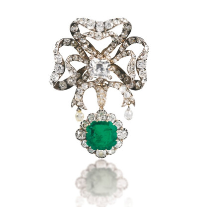 Set with a detachable pendant decorated with a step-cut emerald within a frame of cushion-shaped diamonds, the surmount designed as a bow accented with a carré-cut and cushion-shaped and single-cut di…