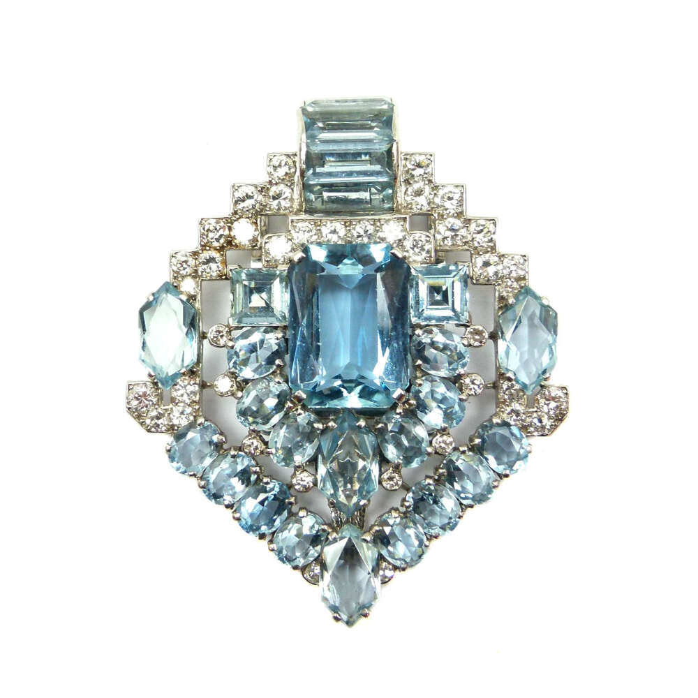 Art Deco aquamarine and diamond clip brooch by Cartier, London c.1935 , the stylised arrow of lozenge outline, centred by a principal rectangular cut aquamarine bordered by oval and fancy cut aquamarines in a geometric design