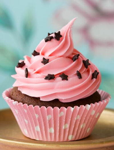 pink cupcake with chocolate star sprinkles