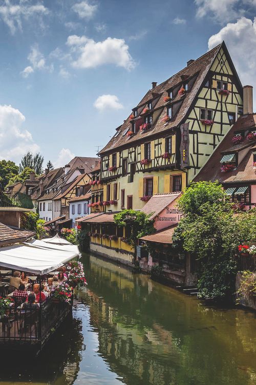 Colmar, Alsace, France。科尔马是法国东北部阿尔萨斯的一个小镇，地处平原，重要的葡萄酒市场。有铁路经过，设有纺织工业学校。科尔马是最浪漫的地区之一，因其境内运河和花船而得名。从桥上可以看到以前船夫和洗衣店在水中的倒影，景色美丽。动画电影《哈尔的移动城堡》中的小镇原型就是法国的科尔马。