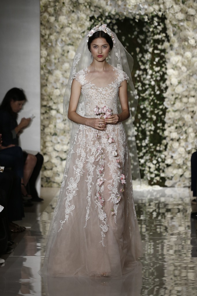 Reem Acra Bridal Fall 2015。雷姆·阿克拉2015秋冬婚纱发布。此季Reem Acra带有古罗马风格的婚纱装饰和头饰诠释了整个系列像古罗马时的盛装一样隆重和华丽。刺绣，蕾丝，丝绸，褶皱纱织等元素充分展现婚纱的高雅格调。同时小白色花卉的世界带来了身临婚纱盛宴的幸福时刻。