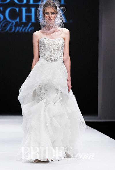 Badgley Mischka Fall 2015 wedding dress collection.巴吉利·米诗卡2015秋冬婚纱发布带着旧时好莱坞式的繁华与性感而来，两位设计师的作品中钉珠刺绣是一大亮点，无论是优雅的鱼尾还是经典的抹胸款式，这一工艺应用…