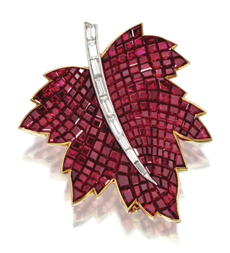 MYSTERY-SET RUBY AND DIAMOND MAPLE LEAF BROOCH, VAN CLEEF &amp;amp; ARPELS, NEW YORK, 1967. Mystery-set with 242 calibré-cut rubies weighing 60.53 carats, the stem set with 9 baguette diamonds weighing 1.02 carats, mounted in 18 karat gold and platinum, signed VCA, numbered NY 38766-2.