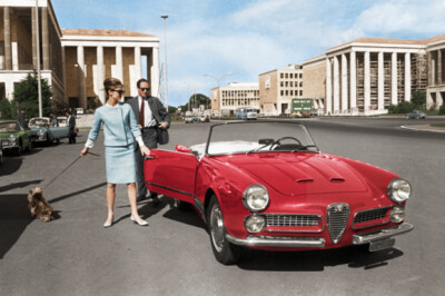 Hepburn with her beloved Yorkie, Mr. Famous, and her first husband, Mel Ferrer, alongside an Alfa Romeo in Rome’s Piazza Guglielmo Marconi, circa 1960.