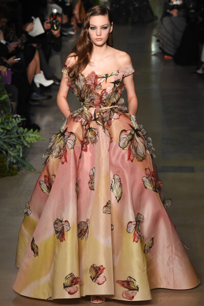 Elie Saab Spring 2015 Couture。艾莉·萨博2015春夏巴黎高级定制时装周在一片片绿色植被花丛中拉开帷幕。本季，以“忧伤的挽歌”向家乡贝鲁特致敬，Elie Saab以“花”为主题，重笔墨于轻盈的流苏与立体花朵装饰之上…