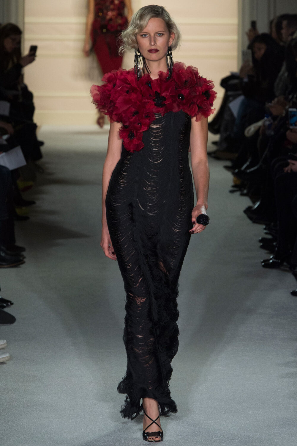 Marchesa Fall 2015 Ready-to-Wear。玛切萨2015纽约时装周秋冬女装秀华丽大胆、恣意风情，像20年代巴黎的名贵水粉，也像美国“爵士时代”漫天的纸醉金迷；像戏梦人生的巴黎交际花，也像菲茨杰拉德笔下的“盖茨比”女郎——如真也似幻。流苏的裙摆窸窣摆动起来，裸露的肌肤闪亮起来，周身的羽毛飞舞起来，媚态饱满的眉眼斜乜起来。Flapper女郎们又仙又接地气儿，明天再说明天的！狐步舞立刻跳将起来——欲望，你好；沉闷，再见！