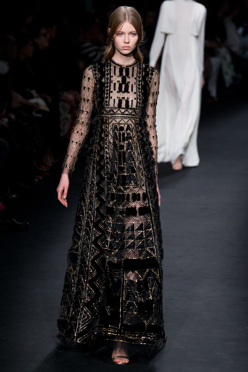 Valentino Fall 2015 Ready-to-Wear。华伦天奴2015巴黎时装周秋冬高级成衣发布。作为专出仙女礼服的Valentino，没想到设计师二人组玩起简约、几何也毫不逊色。本季以两位艺术家（一位是时装设计师Emilie Louise Flöge,另一位是英国面料设计大师Celia Birtwell）的灵感坐镇，除却以往的古典优雅本季又多了醉人的艺术气息。2015秋冬系列前半部分以黑白色调为主，高雅神秘，后半段循序渐进地回归品牌擅长的拜占庭风格蕾丝和图腾。