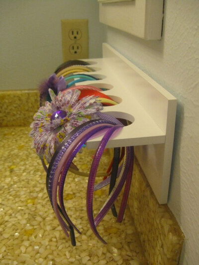 A little craft store rack will hold hair accessories for a little girl’s bathroom. | 51 Game-Changing Storage Solutions That Will Expand Your Horizons