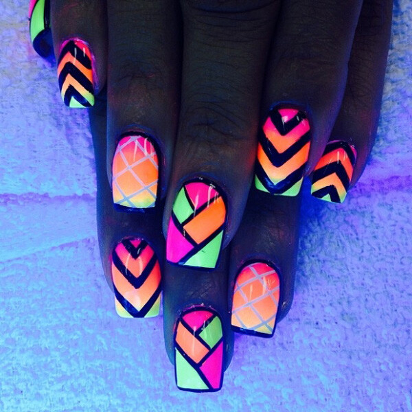 Bold colors and lines are combined to create this amazing looking tribal nail art design. Play with diagonals and stripes over a set of matte and gradient neon base polish.