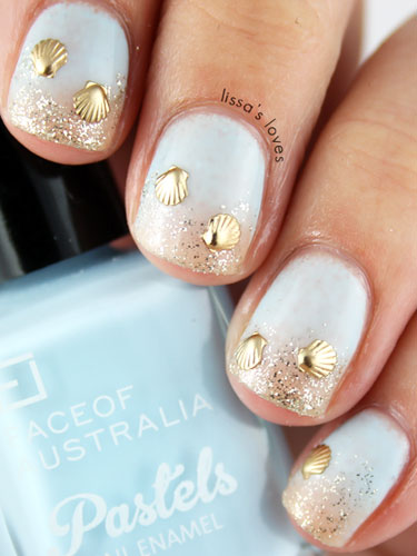 To recreate a similar beach-inspired style like these from Lissa's Love, first paint your nails a shade of light blue. Then, dab gold glitter on the tips of your nails to mimic the sand.