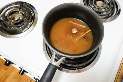 Combine the cider and spices (everything but the booze), and bring to a simmer.