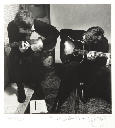 In the photograph, Lennon and McCartney are said to be writing the song “I Saw Her Standing There