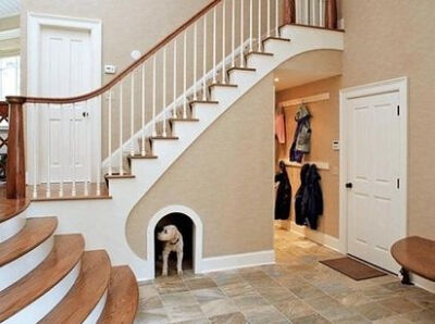 Dogs are people, too, which is why your dog should probably get his or her own little haven underneath the stairs.