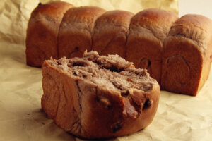 [自制唯美浪漫红酒巧克力吐司] 巧克力红酒面包总重2300g，每个1000g，可做2个。【材料配方】高筋面粉：………… 1000g（100%）砂糖： ………… 200g （20%）盐： ………… 8g （0.8%）干酵母： ………… 15g （1.5%）鸡蛋： ………… 100g （10%）烫种： ………… 100g （10%）可可粉： ………… 30g （3%）红酒： ………… 650g （65%）黄油： ………… 100g （10%）葡萄干： ………… 200g