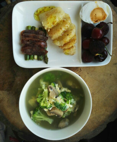 最原始的拍法，做好了放案板上，掏出手机。蘑菇西兰花蛋汤+桂花糍粑粽子+煎腊肠煎芦笋+半个咸鸭蛋+樱桃+杨梅