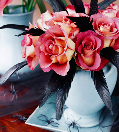 Elegant with Attitude Turn a traditionally sophisticated bouquet of salmon-color roses into a sassy centerpiece by inserting a few black feathers (available at craft and hobby stores) amid the flowers…