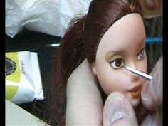 Doll repainting - how to paint Dark Brown eyes. He is painting over an existing blue eye.