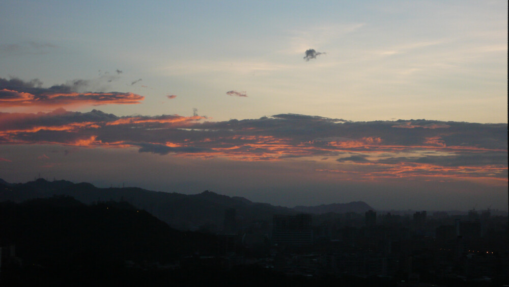 夕陽西下
橘紅色的陽光,灑在層層雲朵之上
穿透出來的夕光
為苦短的人生,增添了一點的幸福
