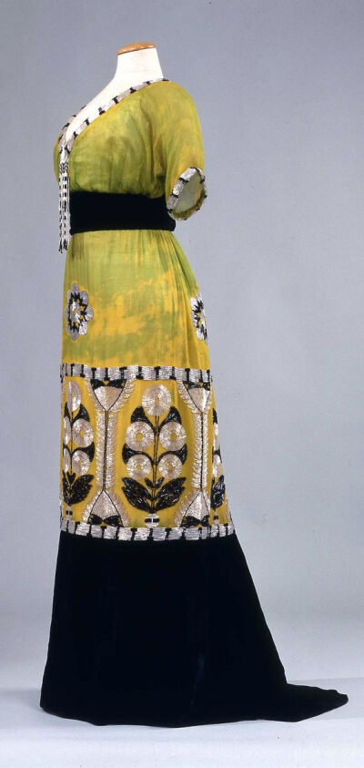 1913 Evening dress Green & yellow chiffon with belt and deep flounce of black velvet, embroidered with glass beads & straws in stylized flower motifs