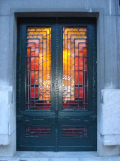 Stained glass panels set in a blue painted door in Brussels.: