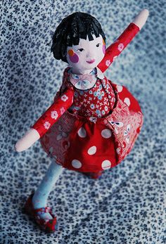 Paper mâché doll, So cute!! I love her eyes & little smile as well as different red print fabric of her garment.