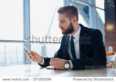 Modern hipster businessman using mobile phone