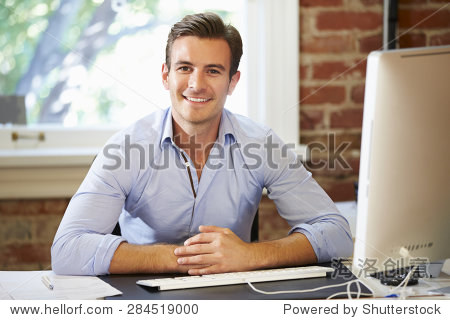 Man Working At Computer In Contemporary Office