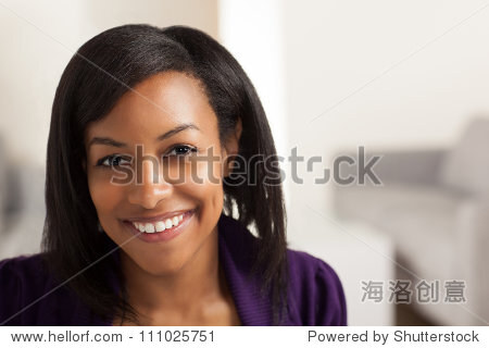 Pretty African American business woman wearing purple jacket and black shirt.