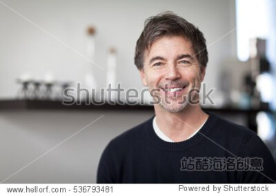 Portrait Of A Mature Handsome Man Smiling At The Camera. Home. Kitchen