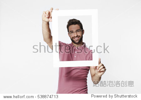 Man holding picture frame to camera, portrait