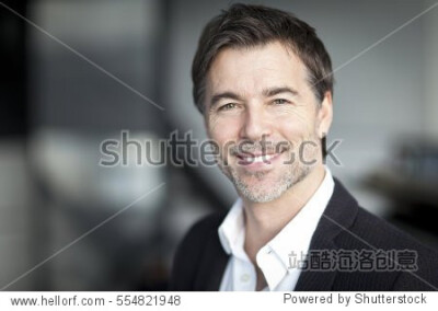 Mature Happy Businessman Smiling At The Camera At The Office