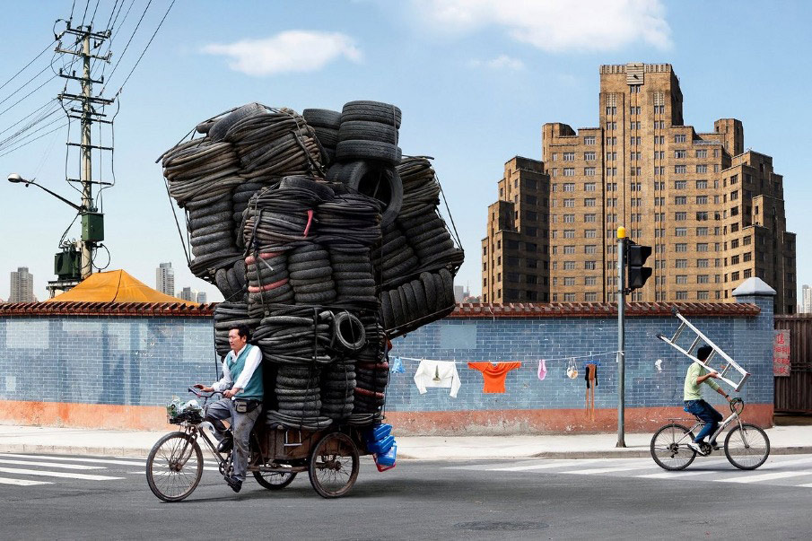 French artist Alain Delorme digitally distorts reality in his series “Totems” in which people are captured around Shanghai with precarious piles of objects.