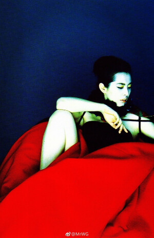 Joey Wong for Vogue Taiwan January 2002 photographed by Lee Shou-Chih.
法国编辑未曾亲睹过王祖贤的电影，替叶锦添画集选照入刊时，却一下相中她为台湾版《沃格》所拍“Drama & Reality”主题editorial残漏的拾遗——
几何形的红绸褶裙来自Issey Miyake，缠绕的流苏金穗，像个诡艳的剪纸娃娃，被尘封于落灰的抽屉内，一身颓废的锦绣华丽；
神巫仙妖般的东方美，冰冷迷幻的墨蓝色，换了现代装的“阿婴”依旧是个不啖凡俗烟火的梦中人，宛若低温的昔日红伶，像达利油画里缺失了时针、分针、秒针的钟，提醒人们时间确确存在，却又不曾逗留在她附近，是恒久不熄的艺术。