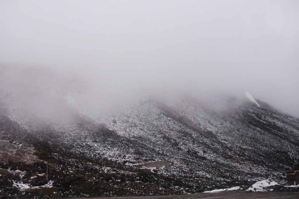 刚刚路过的折多山前两天大雪 今天烈日炎炎都没化完从山下看上去云雾缠绕 但是一进去能见度几乎零一座山翻越了将近20分钟